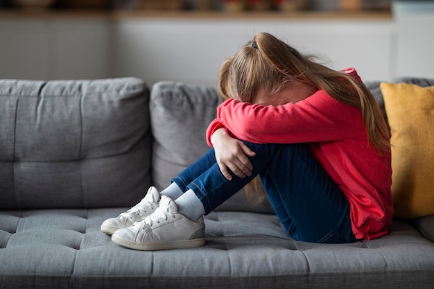 Photo kids depression concept upset little girl crying at home