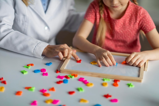 Photo kids development classes unrecognizable little girl playing educational games during psychological