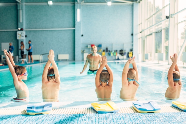 Kids doing exercise in swimming pool