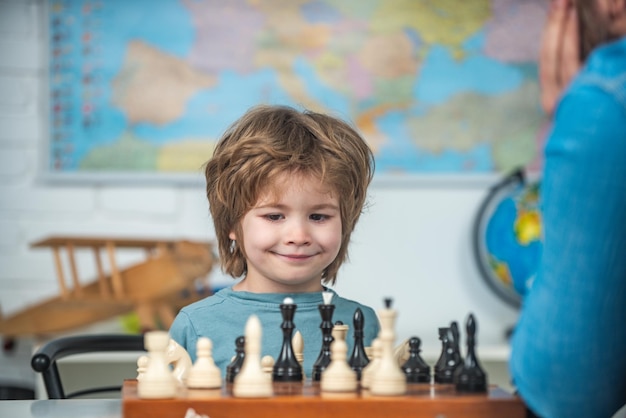 Kids educational games early development Young kid boy playing chess and having fun