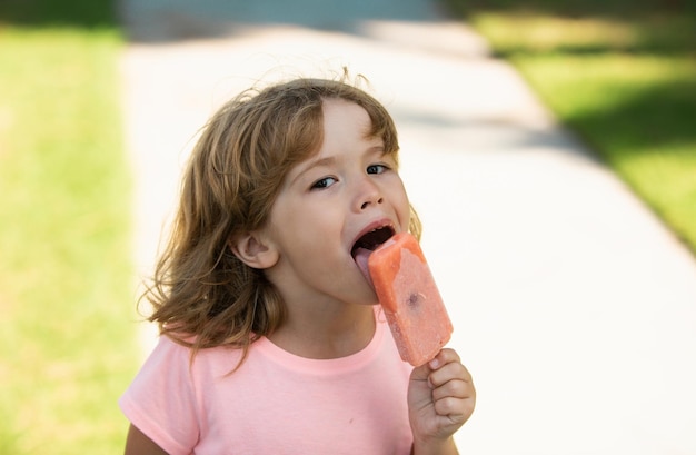 Kids face little boy eating ice cream portrait