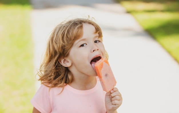 Kids face little boy eating ice cream portrait