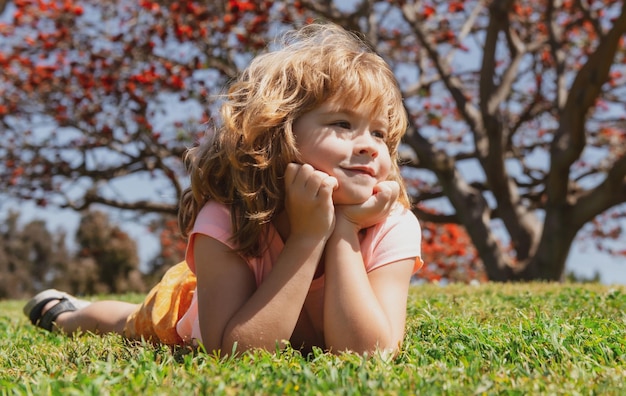 Kids face little boy laying on grass