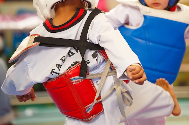 Kids fighting on stage during Taekwondo tournament