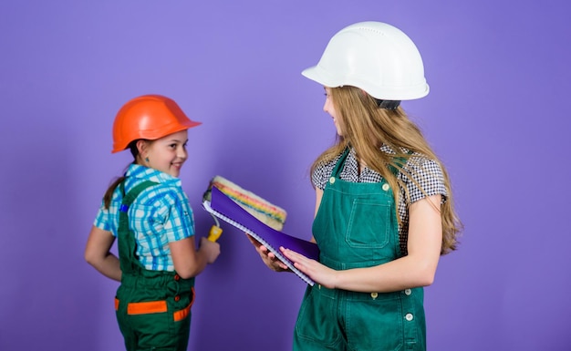 Kids girls planning renovation repaint walls move in new\
apartment children sisters run renovation their room amateur\
renovation sisters team renovating home home improvement\
activities