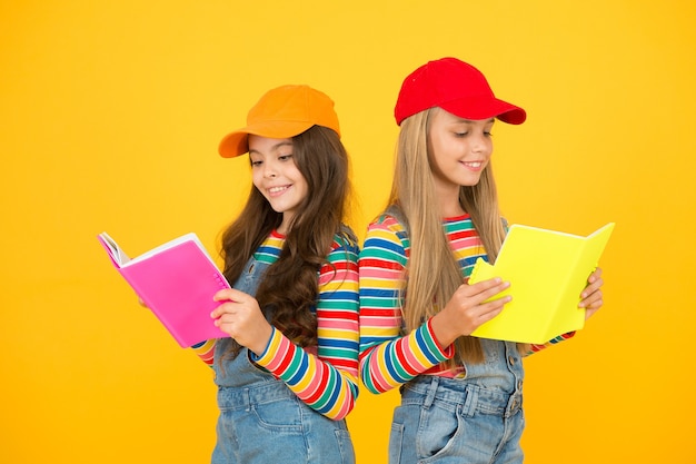 Kids girls with books study together. Back to school. Learning foreign languages. Effective study groups help students learn material deeper. Study group can help solidify and clarify material.