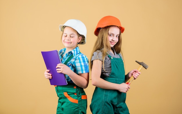 Kids girls with tools planning renovation Family remodeling house Children sisters renovation their room Control renovation process Kids happy renovating home Home improvement activity