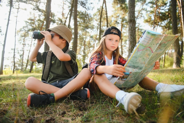 Kids in green forest playingconcept of kids vacations and travel