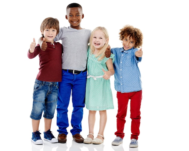 Photo kids group and thumbs up for diversity in studio portrait with smile hug or care by white background girl boy or isolated friends for happiness hand sign or solidarity for children with kindness