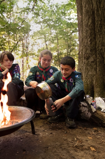 Photo kids having fun as boy scouts