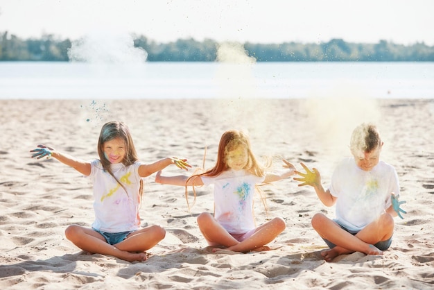 Kids having fun by playing with colored powder