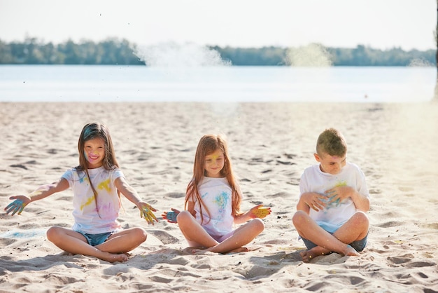 Kids having fun by playing with colored powder