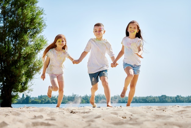 Kids having fun by playing with colored powder