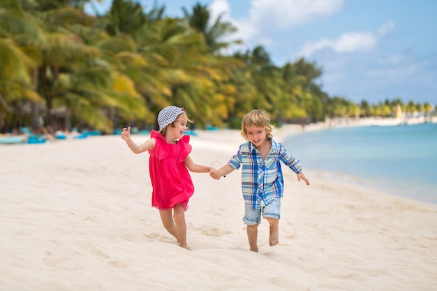 Kids having fun running together in the beach