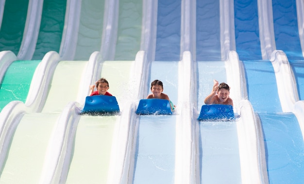 kids having fun sliding in water park