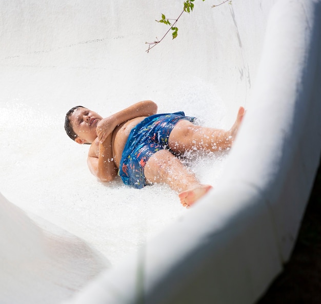 kids having fun sliding in water park