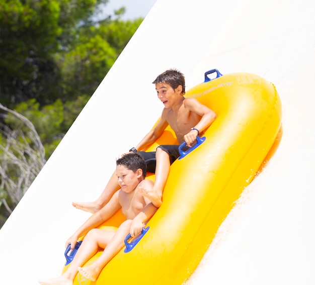 kids having fun sliding in water park