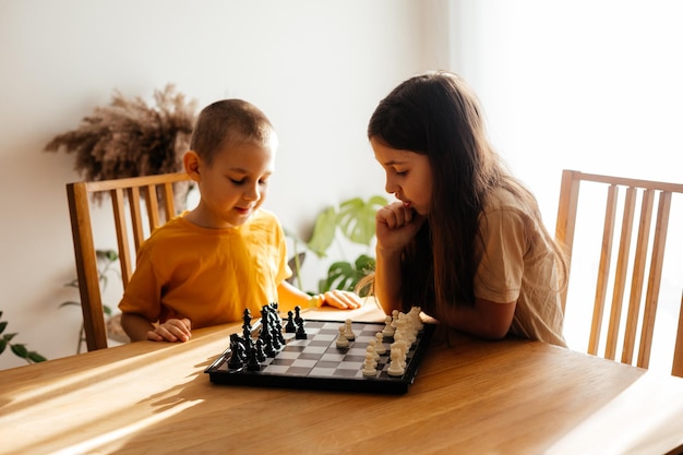 Kids having great time together playing chess