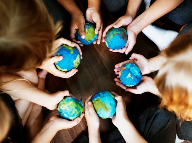 kids holding the world in their hands