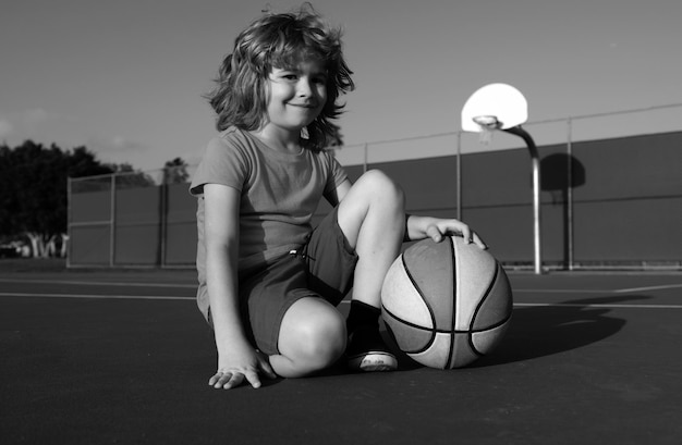 Kids little boy playing basketball child sport activity smiling boy plays ball