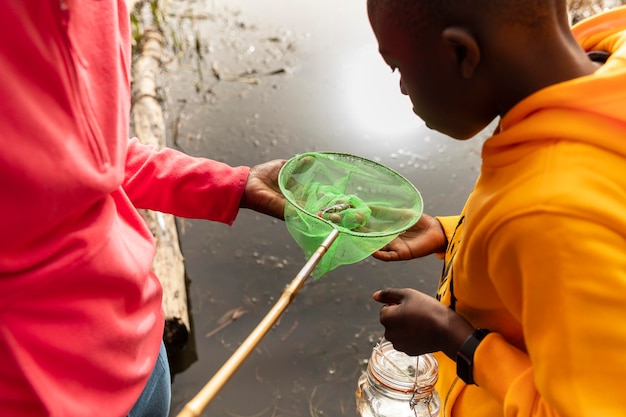 Foto bambini che cercano in uno strumento di pesca
