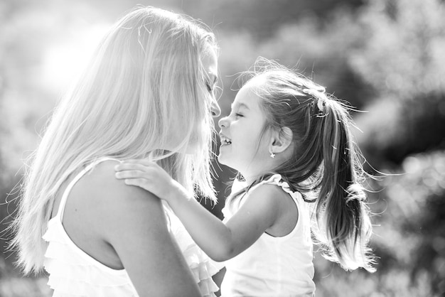 Kids love Lifestyle portrait mom and daughter in happy mood at the outside Happy loving family mother and daughter