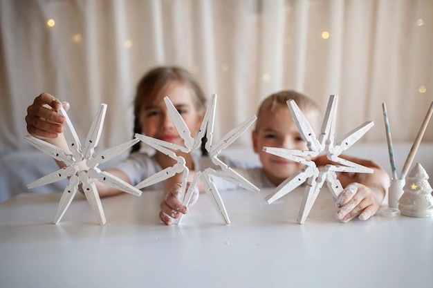 Kids make christmas snowflakes from clothespin reusable original ornament diy new year decoration