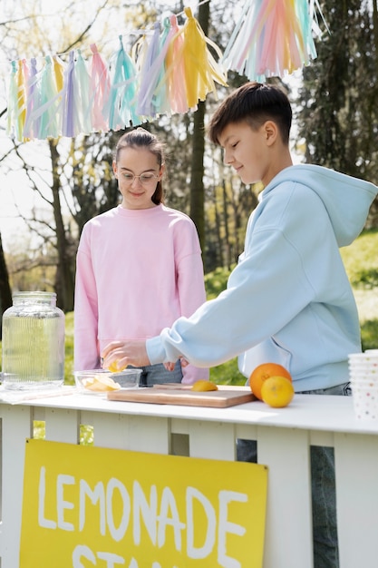 Foto bambini che fanno vista laterale della limonata