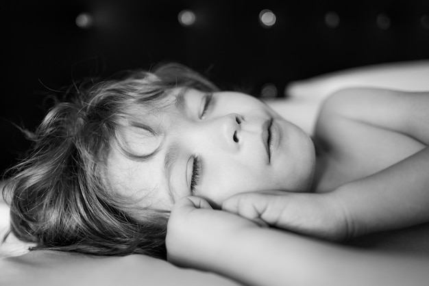 Kids in pajamas sleeping on bed on white background Bed time