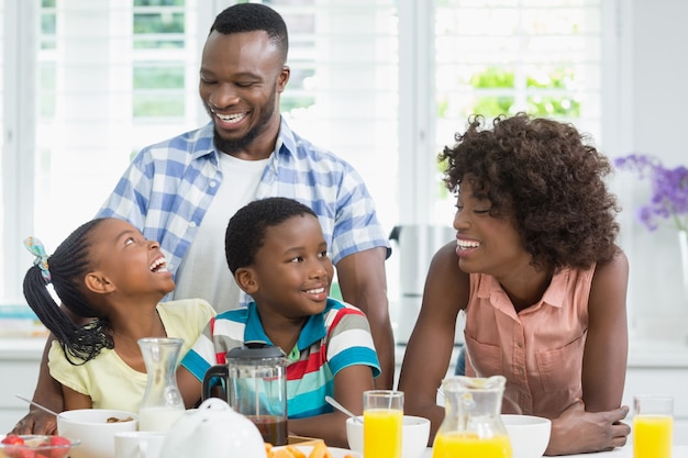 Kids and parents having breakfast on table at home