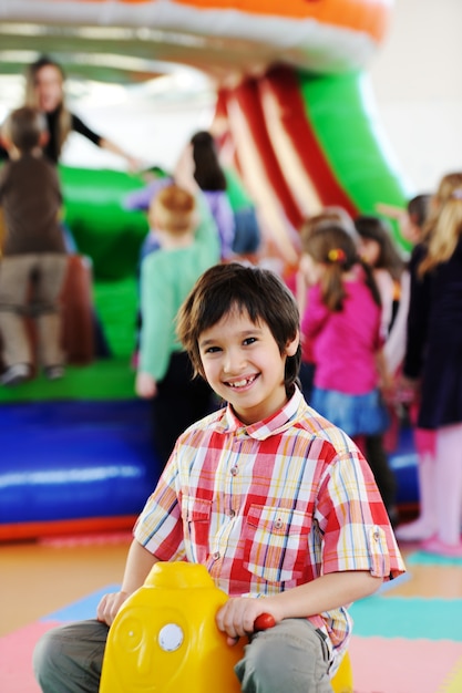 Kids playing on colorful kindergarden playground