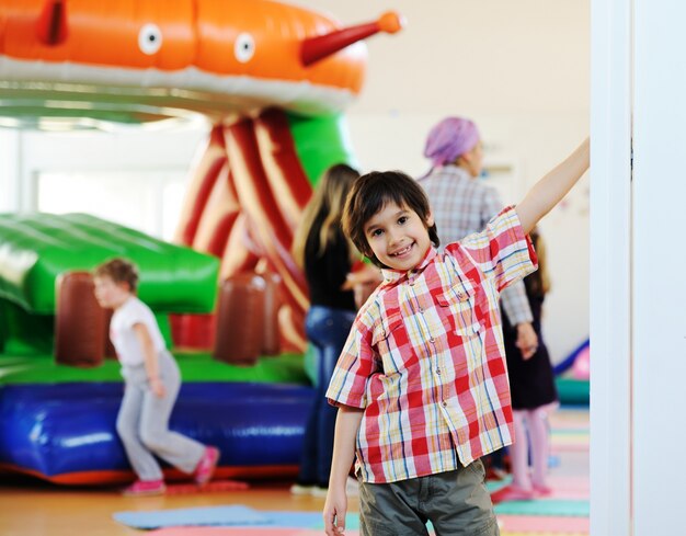 Kids playing on colorful kindergarden playground