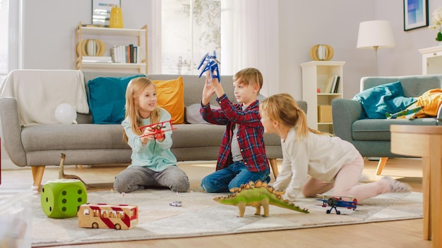 Kids playing in a living room with a dinosaur toy on the floor