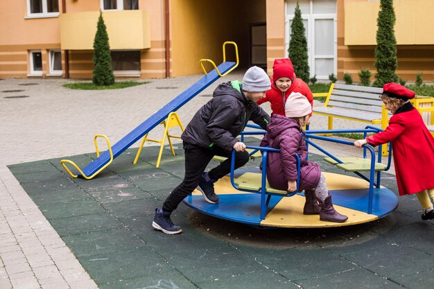 Фото Дети играют на каруселях на открытом воздухе.