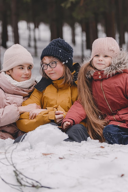 Kids playing in snow Children play outdoors in winter snowfall The concept of Christmas and New Year