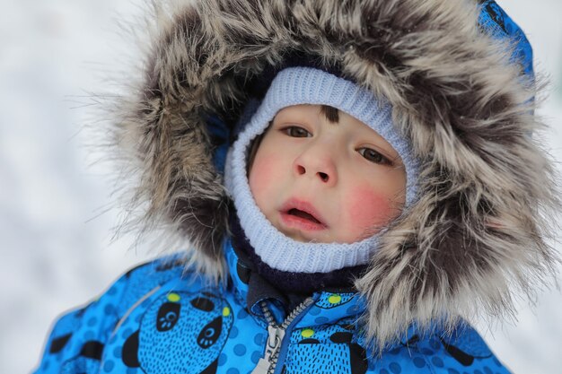 Kids playing with snow in winter on backyard in city