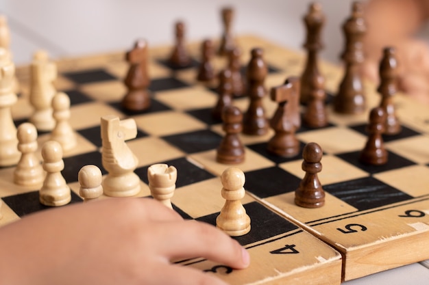 Дети играют в деревянные шахматы в автономном режиме конкурса и концепции стратегии
