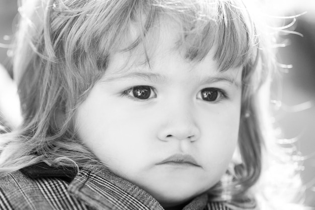 Kids portrait close up head of serious baby child