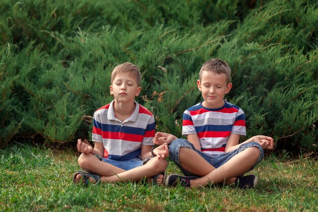 kids practicing Yoga with eyes closed in nature