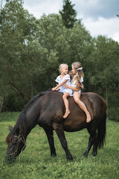 Kids riding horse in the mountains