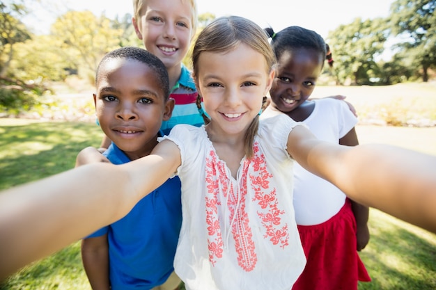 Kids taking a selfie together during a sunny day