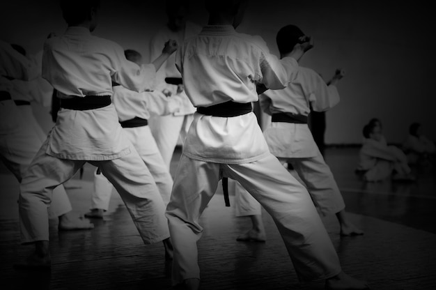Photo kids training on karatedo banner with space for text for web pages or advertising printing black and white photo without faces
