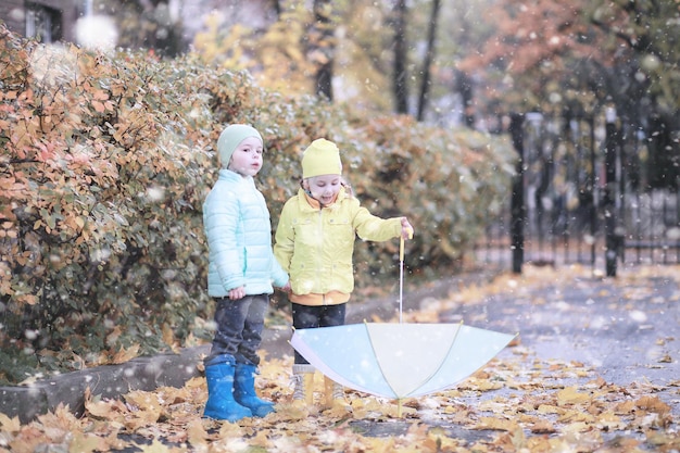 Kids walk in the park first snow