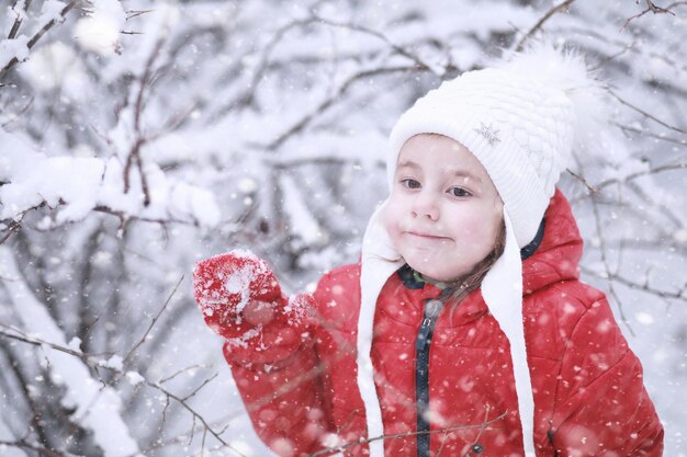 子供たちは最初の雪で公園を歩く