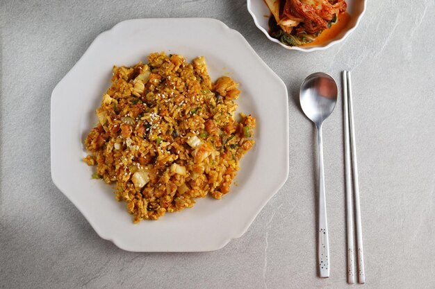 kimchi fried rice or kimchi bokkeumbap with white sesame is Korean food made from rice and kimchi