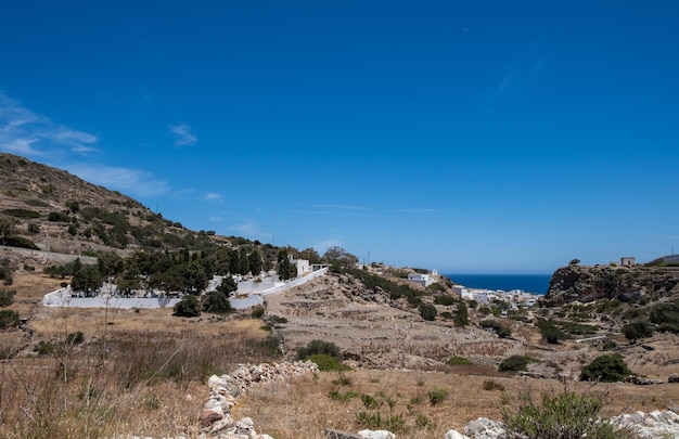 Kimolos island Chora village Cyclades Greece Cemetery at churchyard nature blue sky background