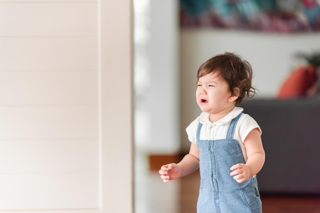 Kind baby kleine persoon huilt thuis pasgeboren huilt en woont binnen in een huis met een familieconcept van kinderzorg en troost