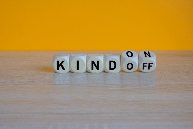 Kind on or off symbol turned wooden cubes and changes word kind off to kind on
