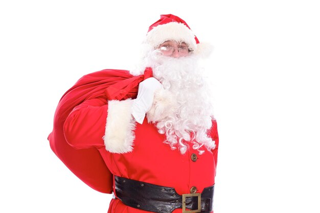 Kind Santa Claus carrying big bag, isolated on white background.