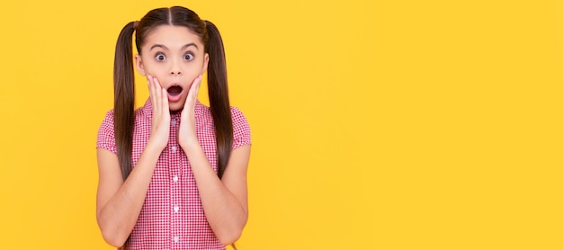 Kind of shocked Kid got shocked Surprised girl yellow background Shock and surprise Child face horizontal poster teenager girl isolated portrait banner with copy space